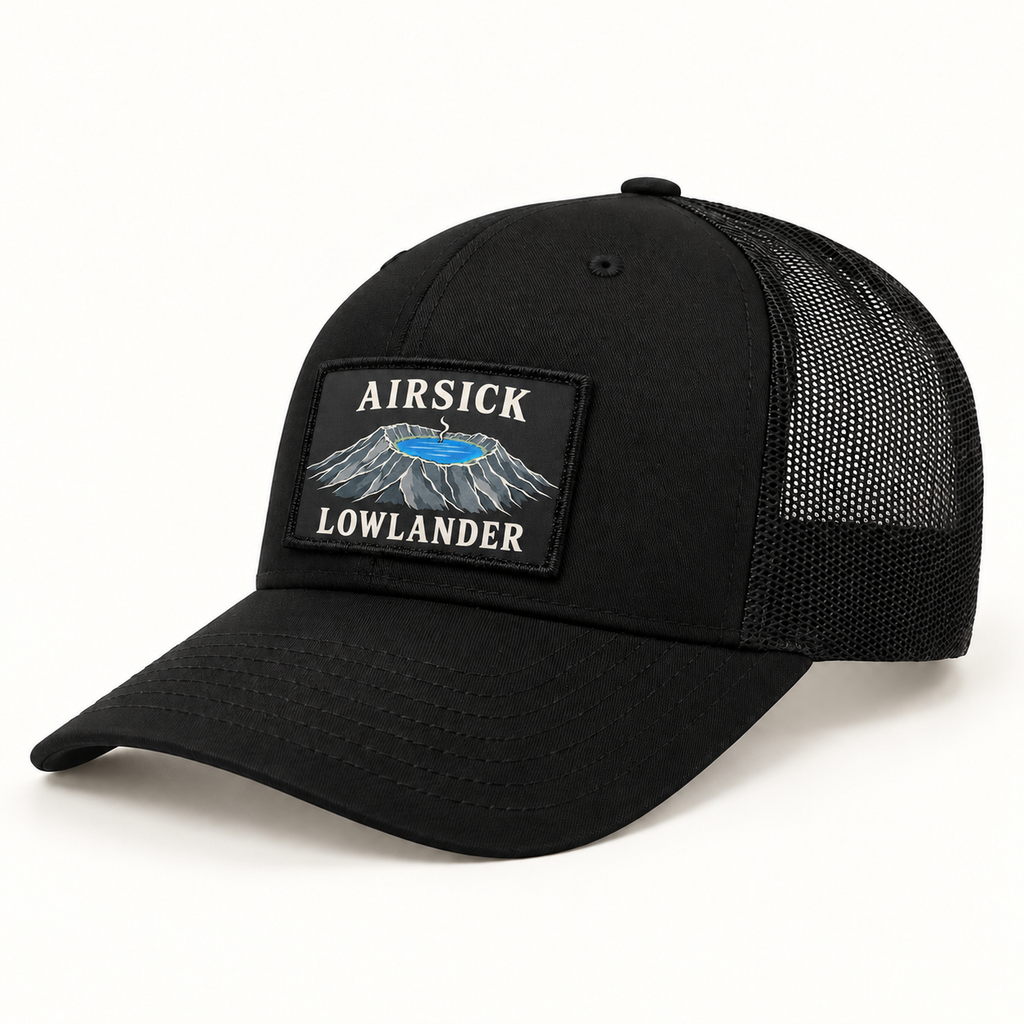 Airsick Lowlander patch illustrated on a black trucker hat. Hat shown for styling; sold separately.